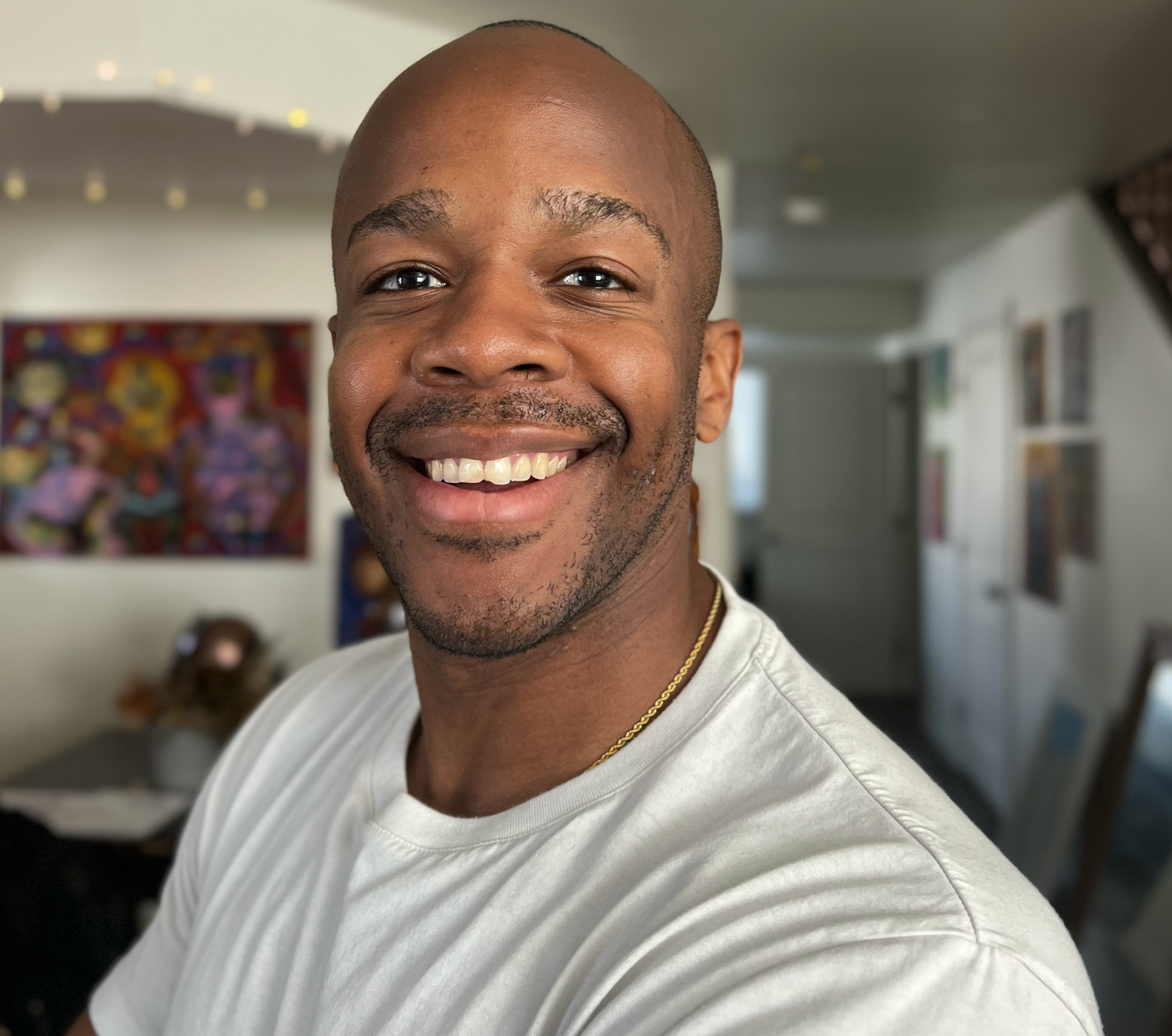 A headshot of Fabrice in white shirt.